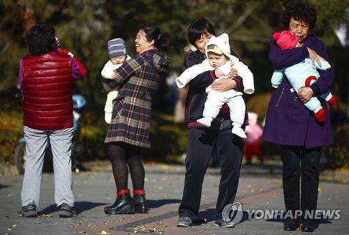 공원에서 아이를 안고 있는 중국인 부모들.(EPA=연합뉴스 자료사진)