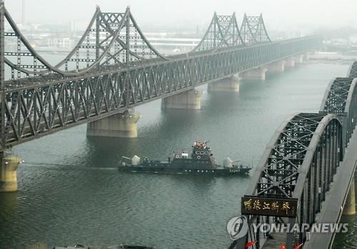 (단둥<중국 랴오닝성>=연합뉴스) 김도훈 기자 = 2일 오후 중국 랴오닝성 단둥과 북한 신의주 사이를 잇는 압록강대교와 압록강단교 사이로 중국 경비정이 지나고 있다. 2016.3.