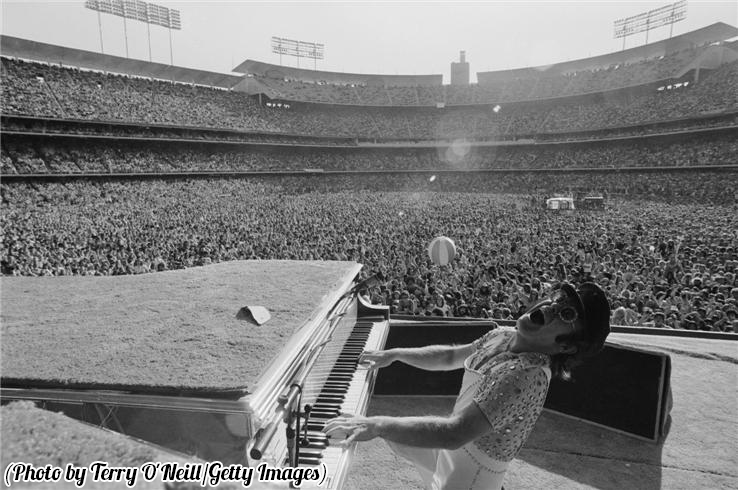 1975 Elton John performs at the Dodger Stadium in Los Angeles.png