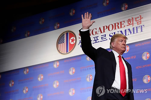 북미정상회담 기자회견 마친 트럼프 (싱가포르 로이터=연합뉴스) 역사적 첫 북미정상회담이 열린 12일(현지시간) 싱가포르 센토사 섬 카펠라호텔에서 도널드 트럼프 미국 대통령이 기자회견을 마친 뒤 손을 들어 인사하고 있다      lkm@yna.co.kr
