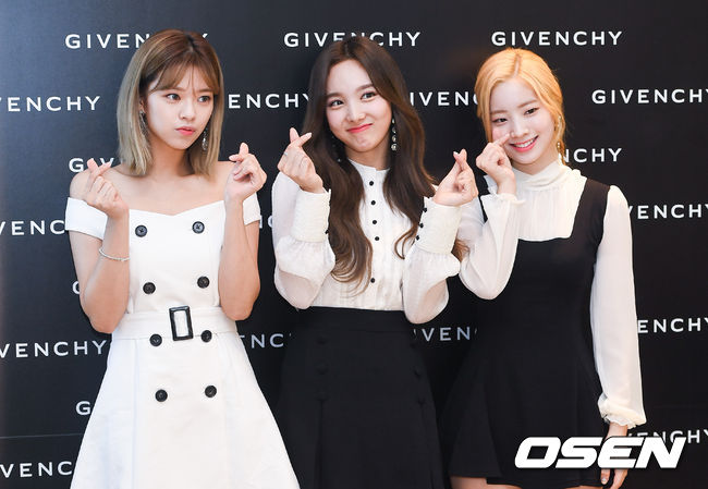Girls group TWICE Nayeon, Jingyeon and Dahyun are posing at the event commemorating the official store of the brand Givenchy held at a store in Shinchon branch of Hyundai Department Store in Seoul on the morning of 7th.