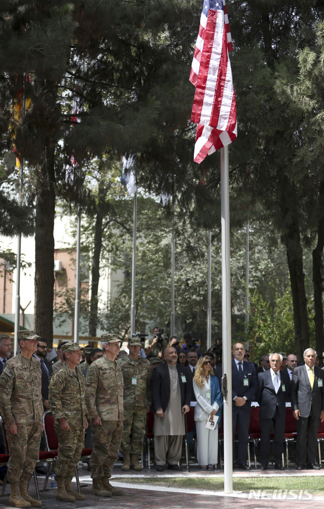 아프간 주둔 미군 및 다국적군 총사령관 이취임식에서 신임 오스틴 밀러 대장(왼쪽에서두번째)과 존 니콜슨 대장(왼쪽세번째)이 나란히 서 있다.    AP