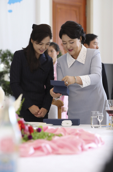 문 대통령 부인 김정숙 여사가 19일 오찬이 진행된 평양 옥류관에서 김 위원장 부인 리설주 여사에게 4·27 남북 정상회담 기념주화를 선물하고 있다.평양사진공동취재단