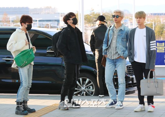 BTS members pose as they enter the departure hall.