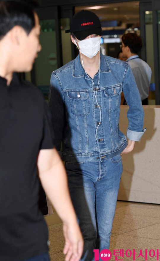 Sehun of group EXO is presenting airport fashion through Entrance through Incheon International Airport after concert in Bangkok, Thailand 24 Days morning.