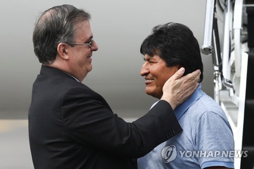 모랄레스(오른쪽) 맞는 에브라르드 장관 [로이터=연합뉴스]