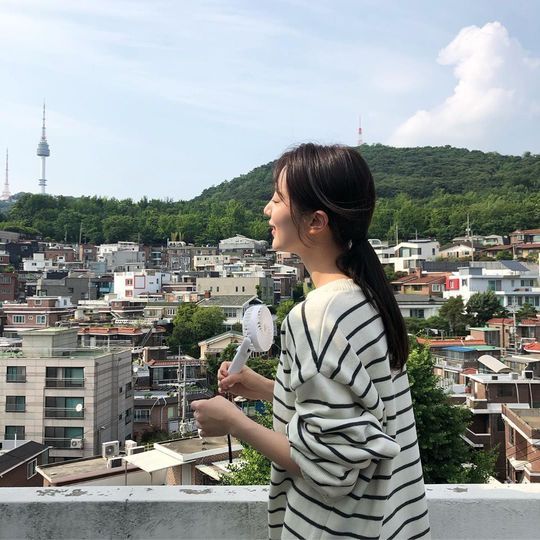 Actor Pyo Ye-jin has released a photo taken during the SBS monthly drama VIP shooting.Pyo Ye-jin posted two photos on his personal instagram on November 19, along with an article entitled On the Rooftop of the Hot Summer Kwon Yuri House.Pyo Ye-jin in the photo is taking a hand fan from the rooftop where Namsan is seen behind.Pyo Ye-jin wore a striped T-shirt and transformed into Kwon Yuri in SBS Drama VIP.Pyo Ye-jin plays Kwon Yuri, who is trying to stand up from poverty on SBS Drama VIP.Kwon Yuri, played by Pyo Ye-jin, was portrayed as a rumored woman of a vice chairman who spread widely inside the department store.Choi Yu-jin