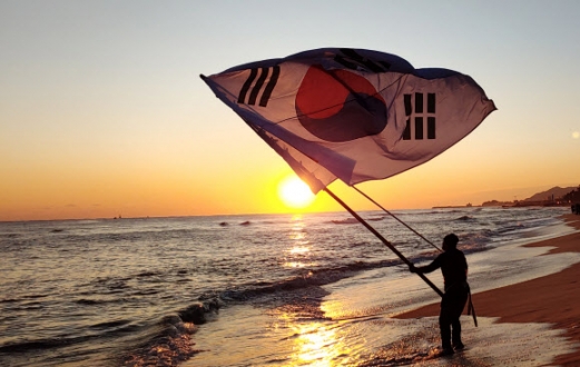 새해 일출 위로 휘날리는 태극기 - 1일 오전 강원도 강릉시 경포 해변에서 태극기를 든 해맞이객이 경자년(庚子年) 새해 첫 해돋이를 맞이하고 있다. 2020.1.1 연합뉴스