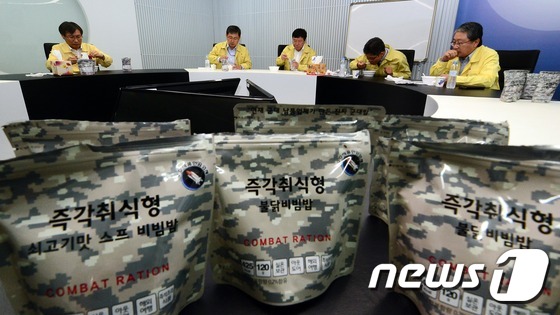 을지연습 첫 날인 22일 정부세종청사 문화체육관광부 소회의실에서 정관주 1차관을 비롯한 실국장들이 비상용 전투식량을 먹고 있다. 2016.8.22/뉴스1 © News1 장수영 기자