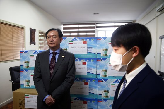 중국의 창화 주이란 대사(완쪽)가 지난달 25일 이란에 진출한 중국 기업과 함께 이란에 마스크 25만 장과 위생키트 5000세트를 기부하고 있다. [로이터=연합뉴스]