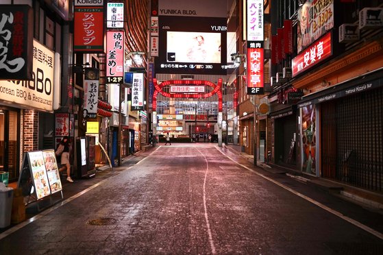 신종 코로나바이러스 감염증(코로나19)의 급속한 확산에 따라 일본 정부가 긴급사태를 선언한 가운데 지난 11일 밤 도쿄의 유흥업소 밀집 지역인 신주쿠 가부키초 거리도 한산해졌다. [AFP=연합뉴스]