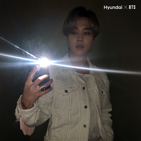 BTS Jimin showed off his brilliant presence, shining even in the dark.The Hydenai Motor Company released a picture of Jimin, who turns on the flash in the dark and takes a selfie with all the lights off with the #DarkSelfieChallenge hashtag on its official SNS account and Instagram.Jimin wore a simple T-shirt and a white vintage denim jacket, and he was sophisticated and stylish, capturing the Sight by radiating a distinctive eyebrow and aura in the dark.Fans who have seen Jimins Selfie in the picture praise Jimins charm.