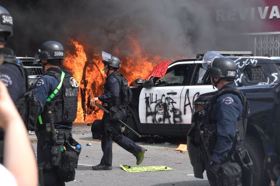 미국 캘리포니아주 로스앤젤레스에서 30일(현지시간) 흑인 사망에 분노한 시위대가 경찰차들을 불태우거나 파손하고 있다. AP뉴시스