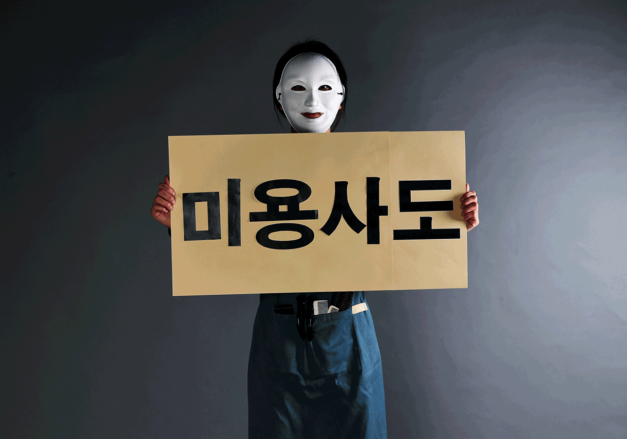 지난달 25일 헤어 디자이너 지민(가명·28)씨가 한국일보 본사 스튜디오에서 '미용사도 노동자다'라고 적힌 피켓을 들고있다.