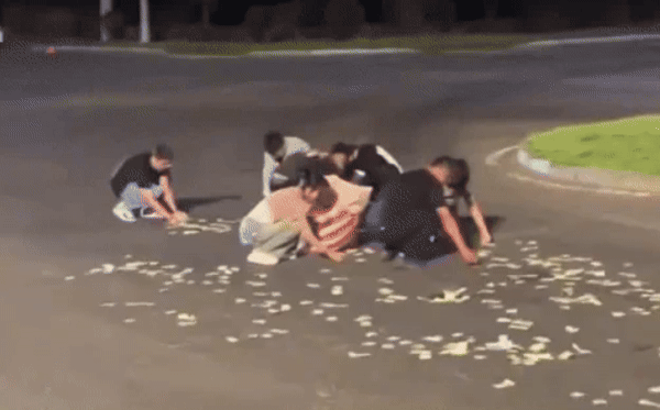 지난달 31일 중국 하얼빈시 핑팡구 한 도로를 달리던 승합차에서 돈 다발이 떨어졌다. 이를 목격한 다른 차량과 행인들이 그냥 지나치지 않고 도로에 쭈그리고 앉아 돈을 줍고 있다. [중국 광명망 갈무리]