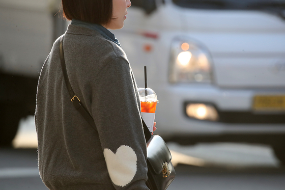A pedestrian in Daegu holds an iced americano in November 2024. [NEWS1]