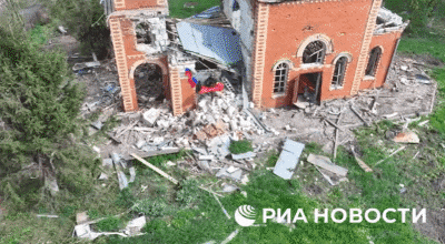 파괴된 교회 건물에서 북한군과 러시아군이 깃발을 꽂은 후 카메라를 향해 손을 흔들고 있다. /리아 노보스티