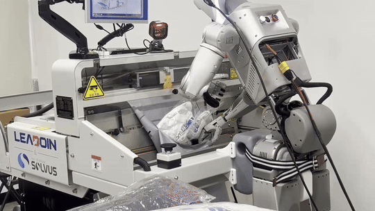 로브로스 휴머노이드 '이그리스-C'가 광운대에서 롯데글로벌로지스 오토배거 실증 작업을 수행하고 있다. 로봇이 폴리백 입구에 걸린 옷을 밀어 넣고 있다. (사진=지디넷코리아 신영빈 기자)