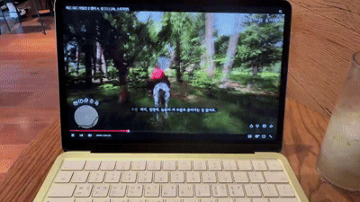 카페 내부에서 맥북 네오로 유튜브 영상을 시청하고 있는 모습.