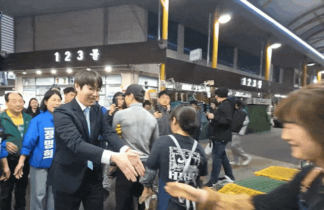 하정우 전 청와대 인공지능(AI) 미래기획수석이 지난 29일 첫 일정으로 부산 북구 구포시장을 찾아 상인과 악수를 나눈 뒤 손을 터는 모습. 온라인 커뮤니티 캡처.
