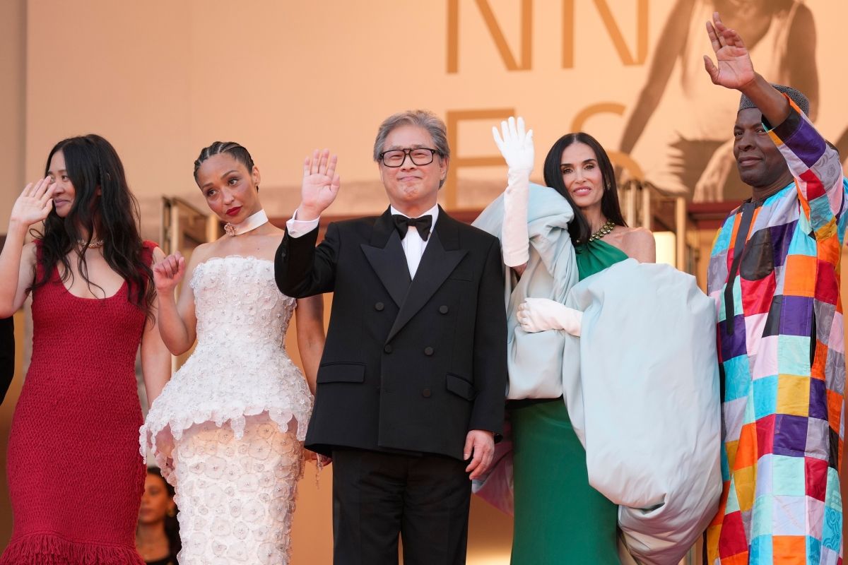 The jury for the competition category of the 79th Cannes Film Festival, led by Jury President Park Chan-wook (center), greets the crowd while entering the closing ceremony at the Lumière Grand Theatre in Cannes, France on the 23rd (local time).